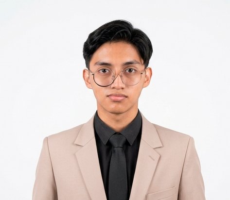 Young man in a beige suit and black tie looking at the camera against a white background, wearing round glasses on a professional portrait.