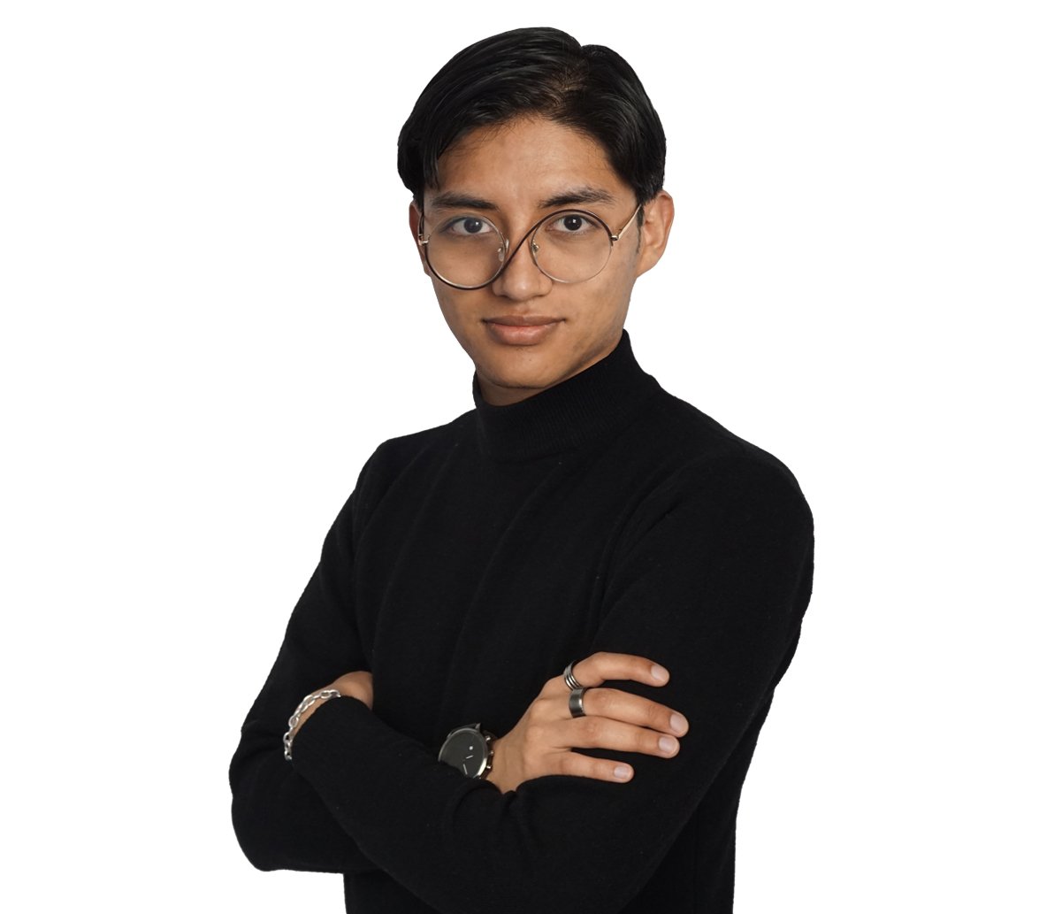 Portrait of a person with short black hair and round glasses, wearing a black turtleneck, arms crossed.